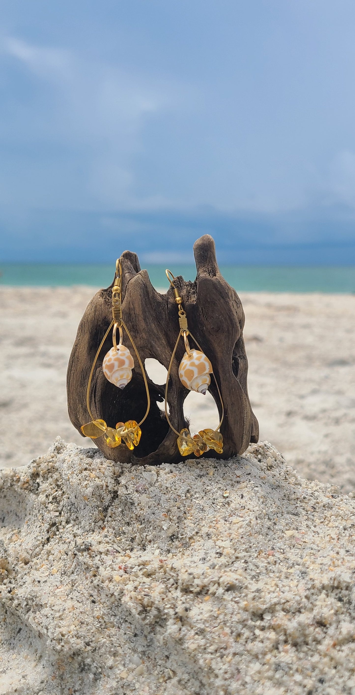 Beautiful Dangle Earrings with Giraffe Print Babylonia Shells and Yellow Amber Colored Stones.